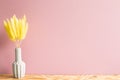 Vase of yellow hares tail grass Lagurus ovatus dry flowers on wooden table Royalty Free Stock Photo