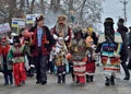 Children and adults dressed as mythological personages walking at traditional Pereberia means `change clothes` carnival,Ukraine