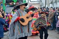 Men dressed as mexican musicians in ponchos and sombreros playing guitars at traditional Pereberia means`change clothes` carniva