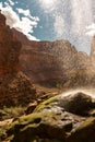 Vast, aerial view of The Grand Canyon in Arizona, featuring a ribbon-like waterfall cascading down Royalty Free Stock Photo