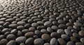 A vast array of smooth, rounded pebbles covers the ground, creating a textured surface. The stones Royalty Free Stock Photo