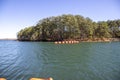 vast blue rippling water at Lake Lanier with large orange buoys in the water and lush green trees with rocks along the banks Royalty Free Stock Photo