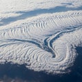 A vast cloud formation resembles a swirling vortex or spiral pattern, captured from Royalty Free Stock Photo