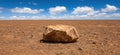 Vast desert landscape with large rock formation Royalty Free Stock Photo