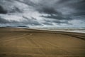 Vast Endless Field Of Sand Beach Over Dramatic Dark Cloud Formation During A Storm In Long Beach Washington