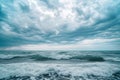 A vast expanse of water stretches as far as the eye can see, with cloudy skies above, Steely blue ocean waves gently rolling under