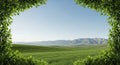 Vast green rolling hills and mountains under a clear blue sky framed by lush green foliage Royalty Free Stock Photo