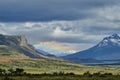 vast open landscape in Patagonia with dramatic sky and a rainbow over a valley Royalty Free Stock Photo