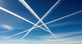 Sky with Contrail Lines from Jet Planes in a Sparse Cloud Setting Aviation Journey Royalty Free Stock Photo