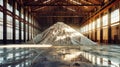 A vast quantity of white sand, used for manufacturing potash fertilizers, is piled high in a warehouse for processing and