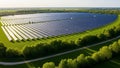 Vast Solar Panel Array in a Lush Green Field Surrounded by Trees Under a Sunny Sky Royalty Free Stock Photo