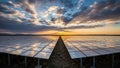 Vast Solar Panel Farm Stretching Towards the Horizon Under a Dramatic Sunset Sky with Sun Rays Royalty Free Stock Photo