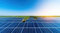 Vast solar panel field under a clear blue sky with sunlight shining brightly Royalty Free Stock Photo