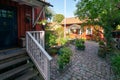 Vastervik, Sweden - 08.23.2021: Wide shot of yard of old, traditional red wooden house in scandinavian style. Sunny