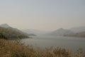 Vastly stretched foggy lake at sunset