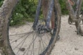 VASTO, ITALY - APRIL 29, 2023:  A mountain biker is making a stop on a very dirt road. Close up shot of the muddy wheel Royalty Free Stock Photo