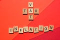 VAT and Tax crossword, and the word inflation, on red background Royalty Free Stock Photo