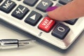 VAT or tax return concept with hand calculator buttons and finger pressing keyboard Royalty Free Stock Photo