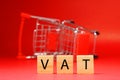 VAT Value Added Tax word on blur shopping cart background - Red pattern of Business and Planning cost investment concept - Calcu Royalty Free Stock Photo