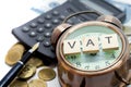 VAT word on Alarm clock and stacks coins Royalty Free Stock Photo