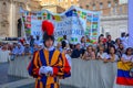 A portrait of a swiss guard in Vatican city, crowd of people in the main square waiting for the holy mass on sunday with Pope Royalty Free Stock Photo