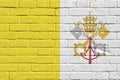 Vatican City State flag depicted in paint colors on old brick wall. Textured banner on big brick wall masonry background Royalty Free Stock Photo