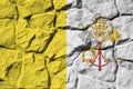Vatican City State flag depicted in paint colors on old stone wall closeup. Textured banner on rock wall background Royalty Free Stock Photo