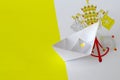 Vatican City State flag depicted on paper origami ship closeup. Handmade arts concept