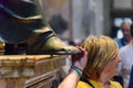 Person touching the foot of Saint Peter statue. Interior of Saint Peter`s Basilica in Vatican