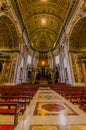 VATICAN, ITALY - JUNE 13, 2015: Altar inside Saint Peter basilica in Vaticano, nobody on the red chairs. Large beautiful