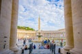 VATICAN, ITALY - JUNE 13, 2015: Great view outside Vatican Basilica, between columns the obelisk and fountaine with Royalty Free Stock Photo