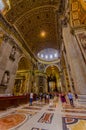 VATICAN, ITALY - JUNE 13, 2015: Indoor view of Vatican Basilica, Sain Peter. Tourists enter and looking to scultures Royalty Free Stock Photo