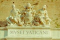 VATICAN, ITALY - JUNE 13, 2015: Wall signboard to enter to Vatican Museums, sculture with Vatican seal