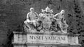 Vatican Museums written in Italian at the external entrance of the museums on the Vatican walls, with a group of marble statues an Royalty Free Stock Photo