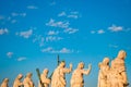 Back view on the statues on the balustrade of St. Peter`s Basilica facade represent Christ the Redeemer, St. John the Baptist and