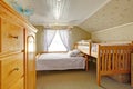 Vaulted ceiling bedroom with low and high beds Royalty Free Stock Photo