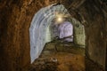 Vaulted tunnel with concrete walls in old abandoned bunker, mine, drainage, subway, etc