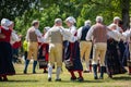 Vaxjo, Sweden, June 2023: People gathered around Maypole during Swedish Midsommar festival in traditional dressing