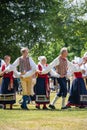 Vaxjo, Sweden, June 2023: People gathered around Maypole during Swedish Midsommar festival in traditional dressing