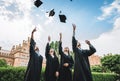 We`ve finally graduated!Graduates near university are throwing up hats in the air Royalty Free Stock Photo