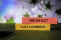 We`ve Got You Covered on the sticky notes with bokeh background Royalty Free Stock Photo