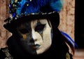 VE, ITALY - Feb 09, 2016: Masqueradin costume at the Carnival of Venice, wearing a black hat decorated with buttons