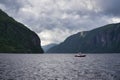 VEAFJORD, NORWAY - CIRCA JULY, 2017: Lone boat drives on the fjord