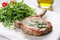 veal chop on a bed of arugula on a marble countertop Royalty Free Stock Photo