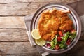 Veal Milanese with lemon and fresh salad of tomatoes and lettuce