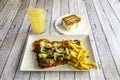 Veal Milanese menu with slices of Parmesan cheese, pesto sauce, garnish Royalty Free Stock Photo