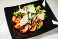 Veal steak salad with arugula, lettuce, tomato, olives and parmesan cheese Royalty Free Stock Photo