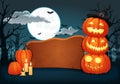 Wooden signboard with candles and glowing halloween pumpkins with witch hat. Royalty Free Stock Photo