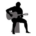 Vector silhouette of a male tourist with a guitar. Man sitting and playing a musical instrument isolated on white background Royalty Free Stock Photo