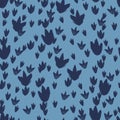 Vector blue dinosaur footprints repeat pattern. Perfect for textile, giftwrap and wallpaper.